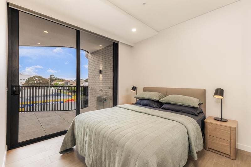 Main bedroom with queen bed opening onto the balcony in an Arte Living Caringbah two bedroom apartment