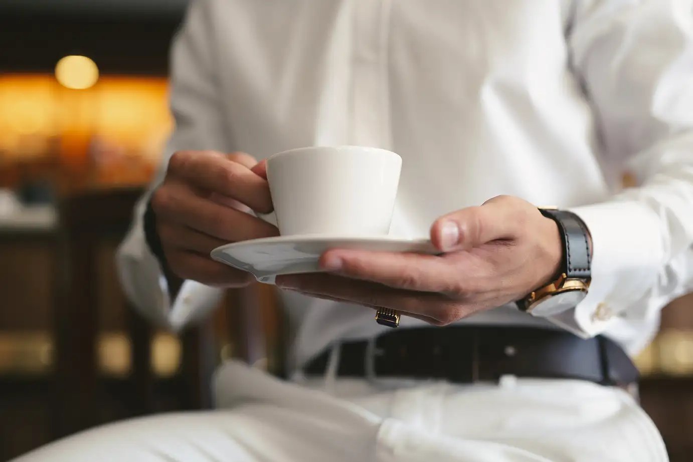 an-elegant-man-in-a-white-suit-drinks-coffee-from-2026-01-07-00-41-30-utc copy