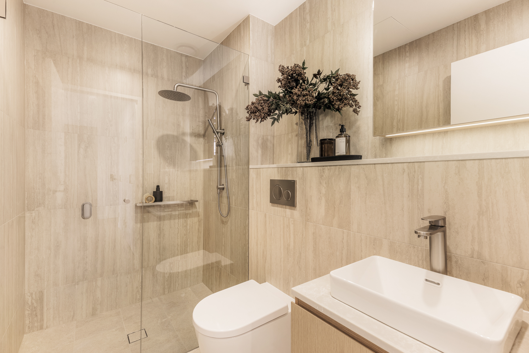 Arte Living Caringbah one bedroom bathroom with walk-in rain shower and stone-look tiles