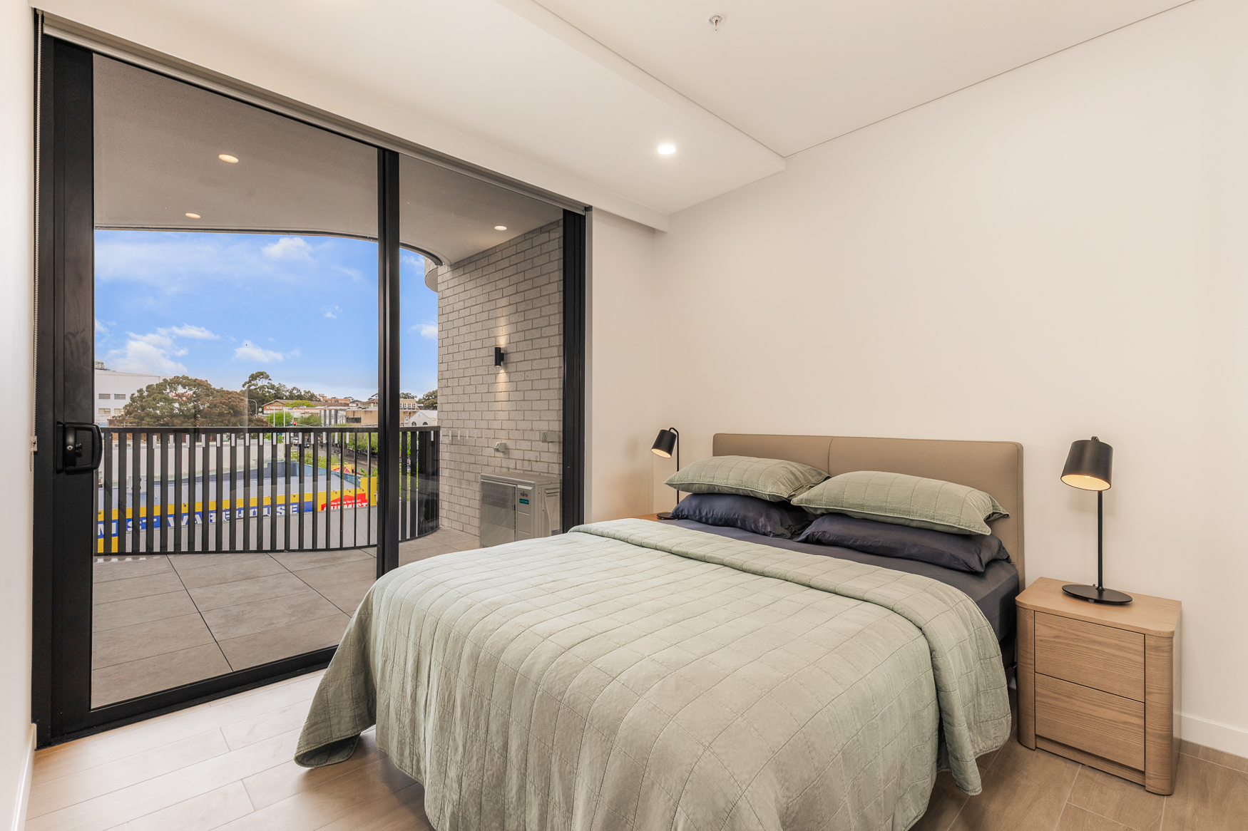 Main bedroom with queen bed opening onto the balcony in an Arte Living Caringbah two bedroom apartment
